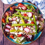 Asparagus salad on a large round plate.