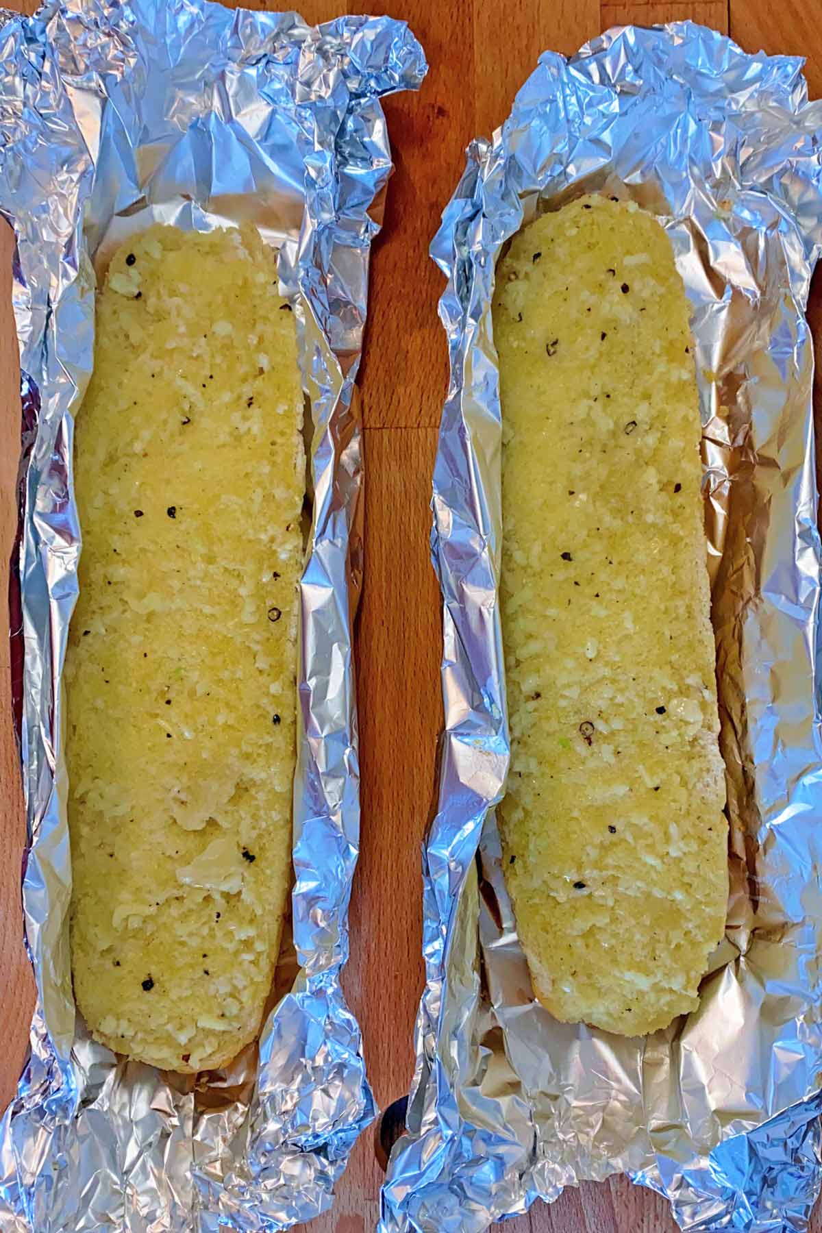 Part cooked garlic bread in foil.
