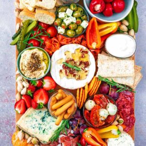 A grazing platter containing various meats, cheeses and vegetables.