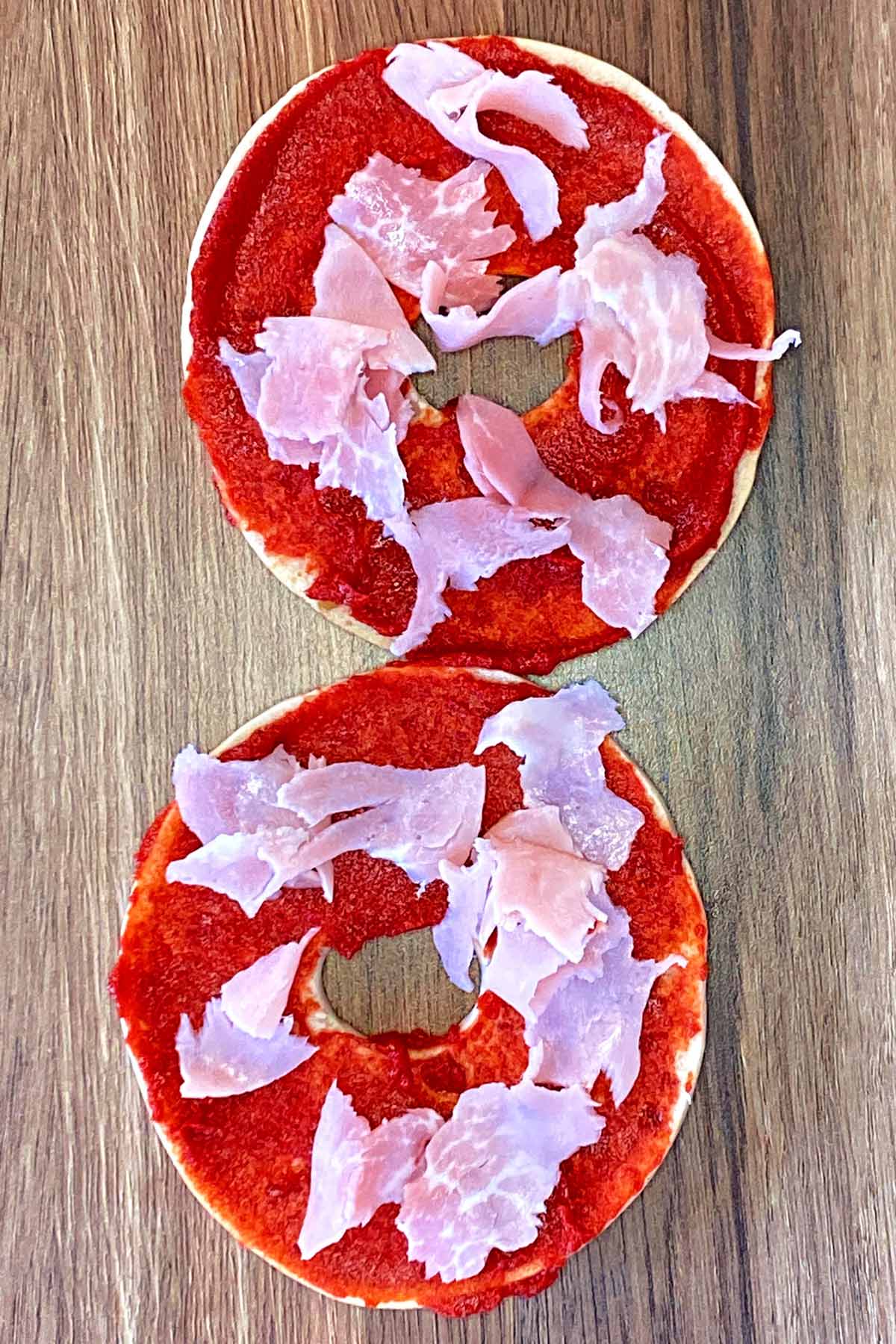 Small pieces of ham added to the bagel.