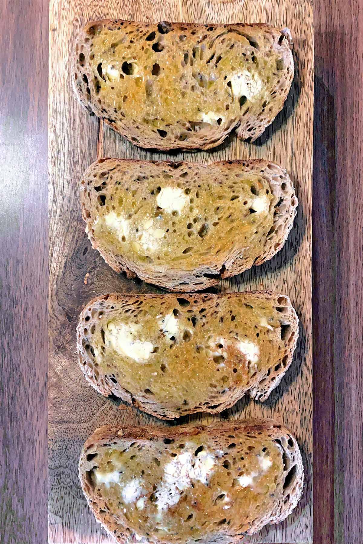Four slices of toasted and buttered bread.
