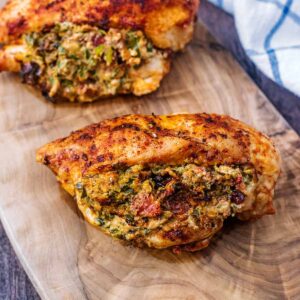 Air Fryer Stuffed Chicken Breast on a wooden serving board.