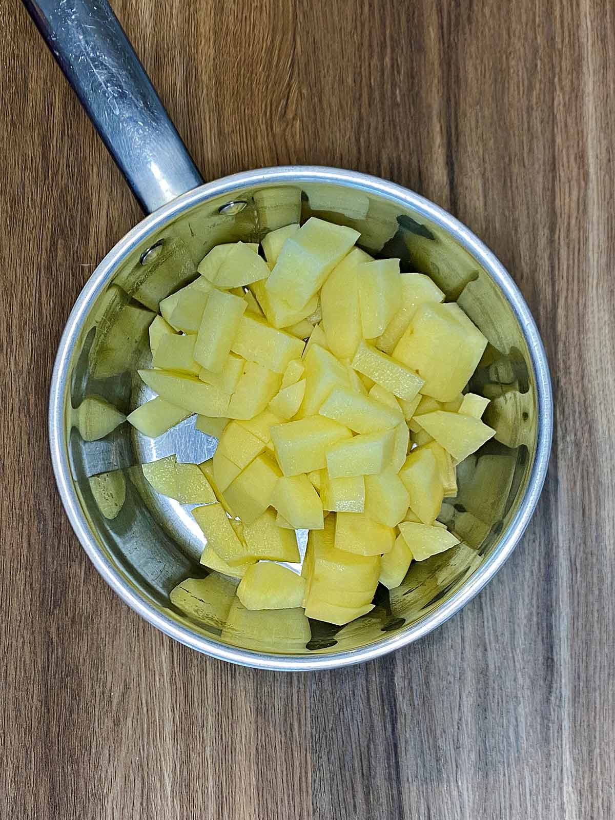 Cubes of potato in a saucepan.