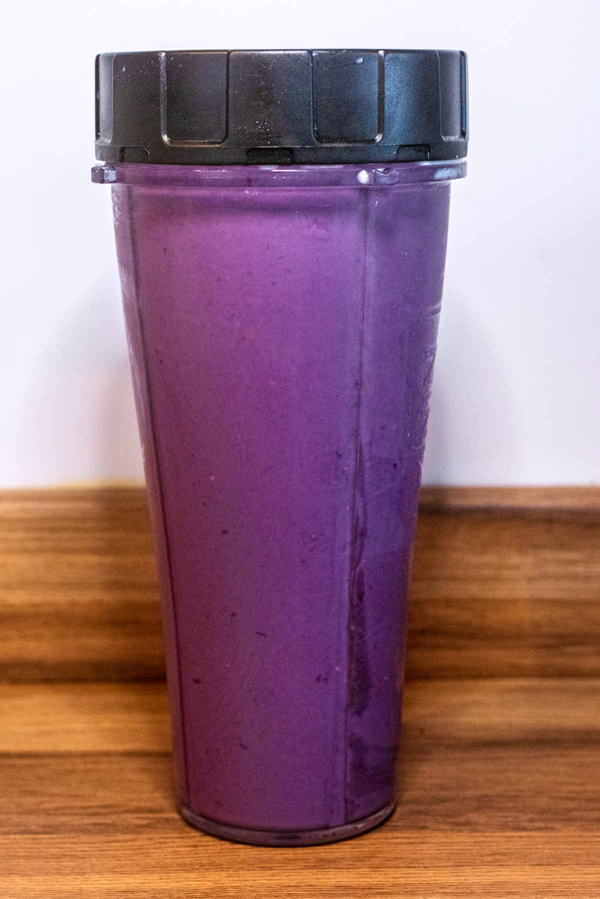 Blended purple smoothie in a blender jug.