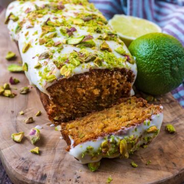 Courgette and lime cake with a slice cut off.