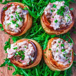 Four vegetarian vol au vents sat on a bet of rocket lettuce.