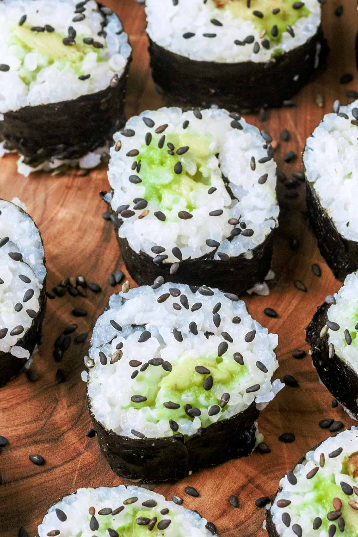 Two sushi maki with avocado fillings.
