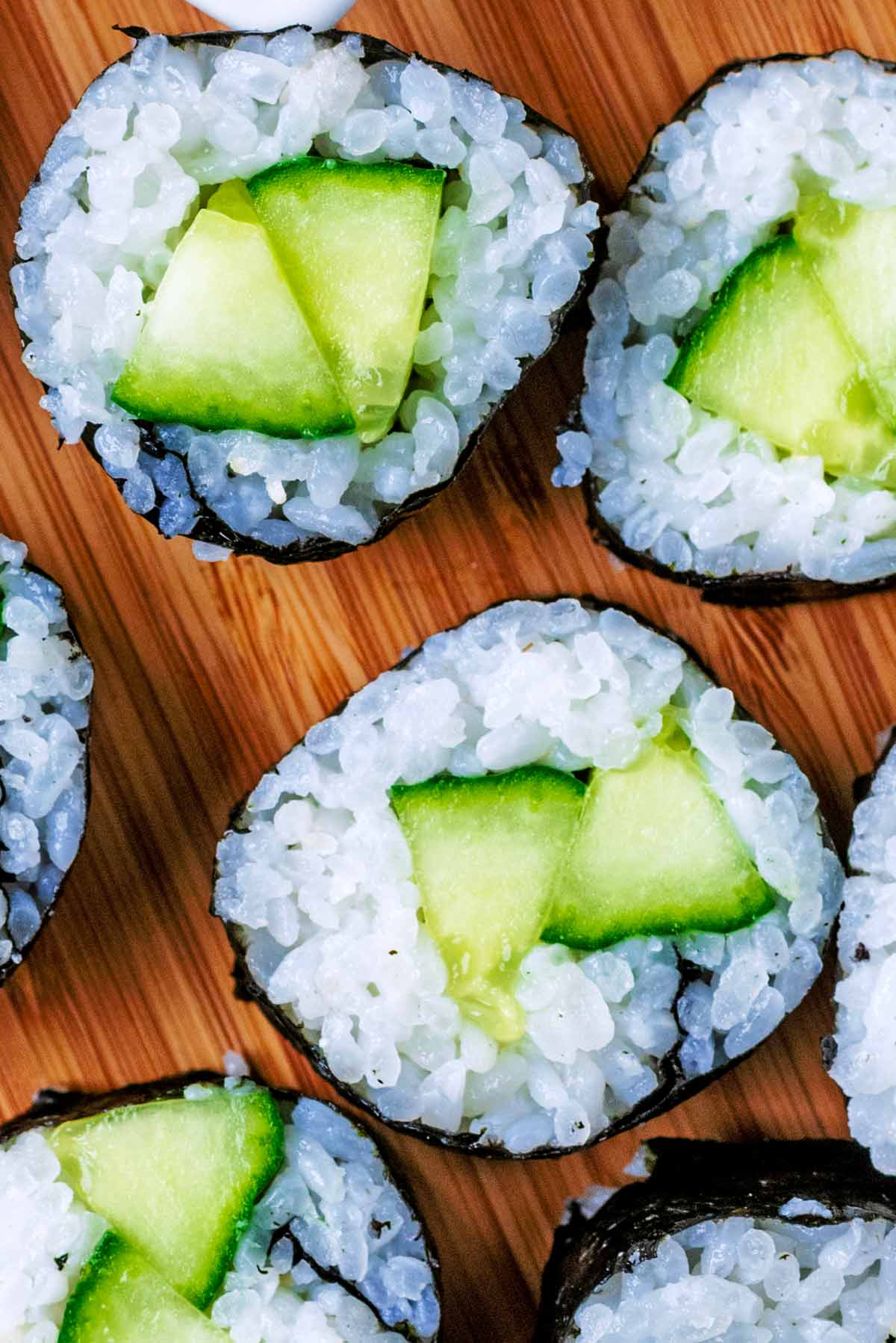 Two pieces of cucumber sushi as viewed from above.