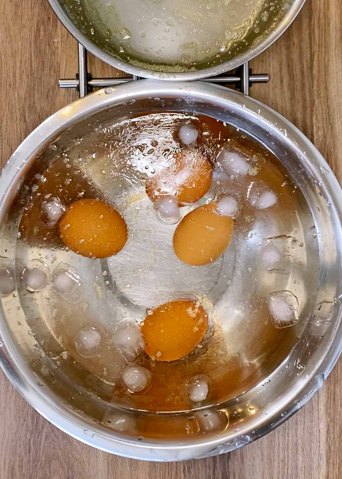 Boiled eggs in a bowl of iced water.