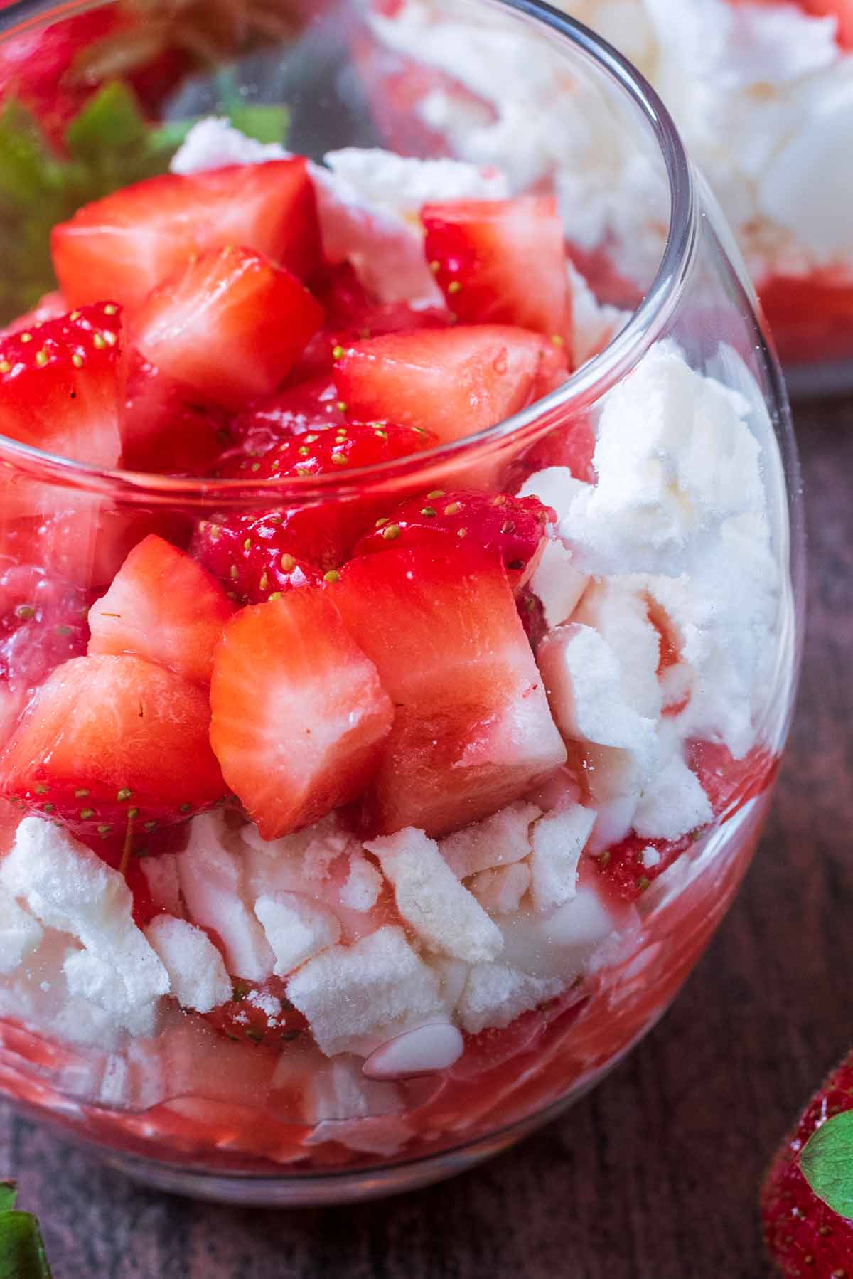 Strawberries, crushed meringue and yogurt layered in a glass.