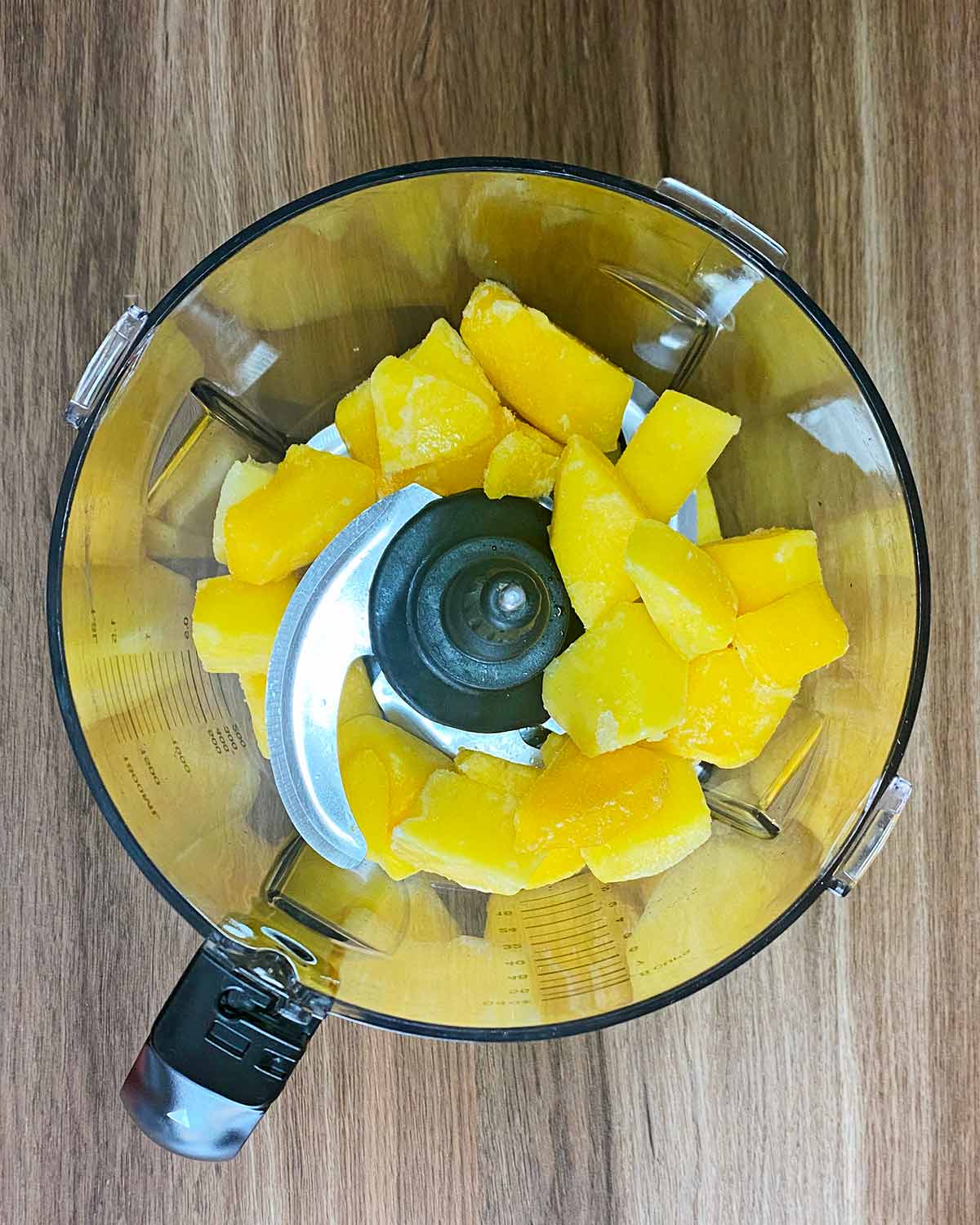 Chunks of mango in a food processor.