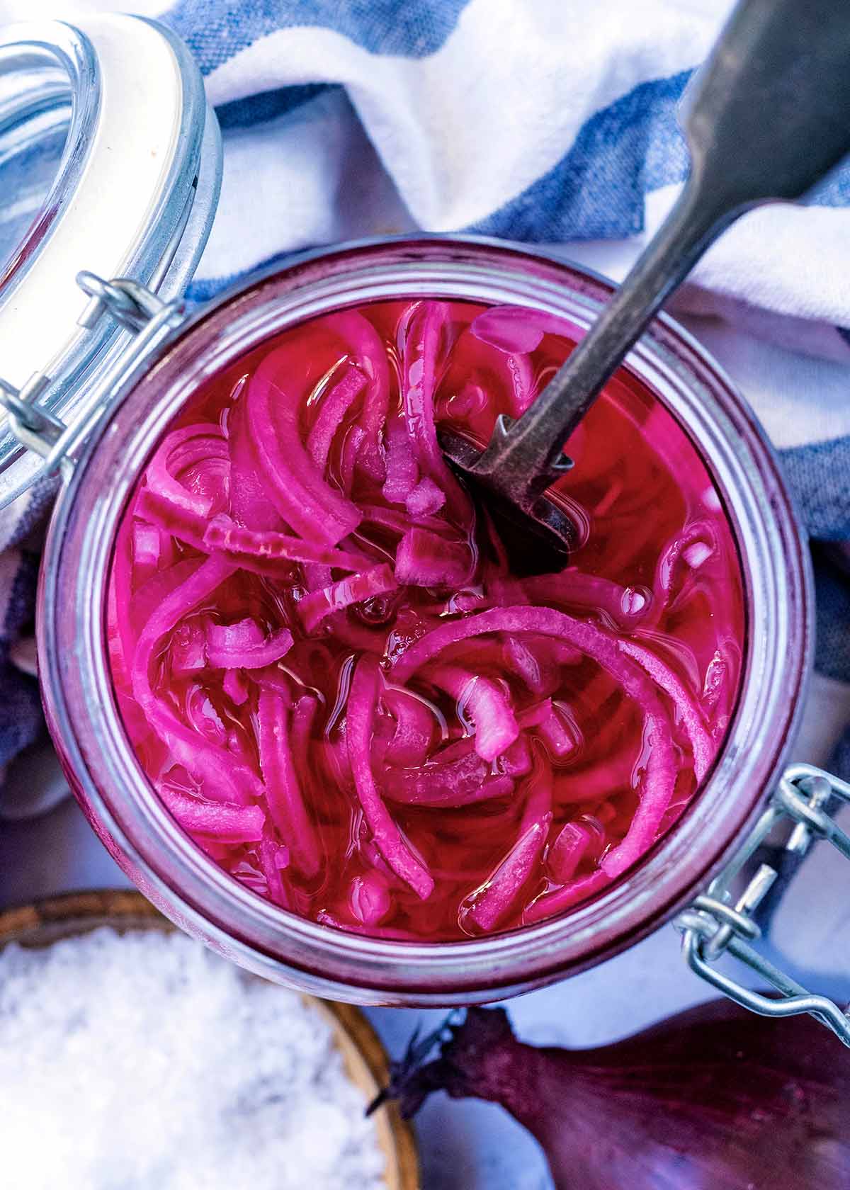 A jar of sliced red onions as viewed from above.