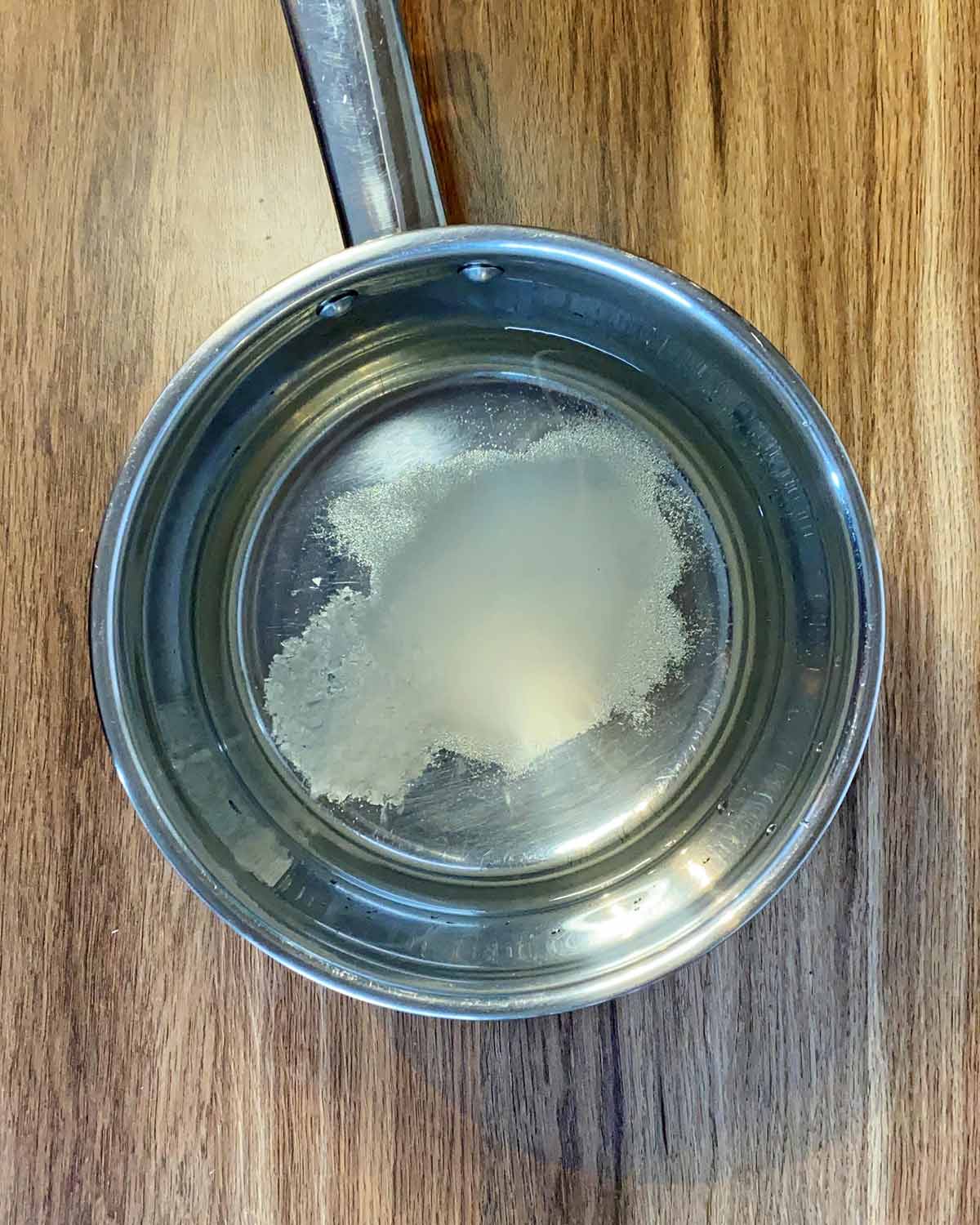 A saucepan with water, vinegar and sugar in it.