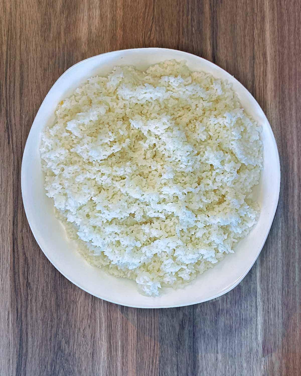 Cooked sushi rice in a large serving bowl.