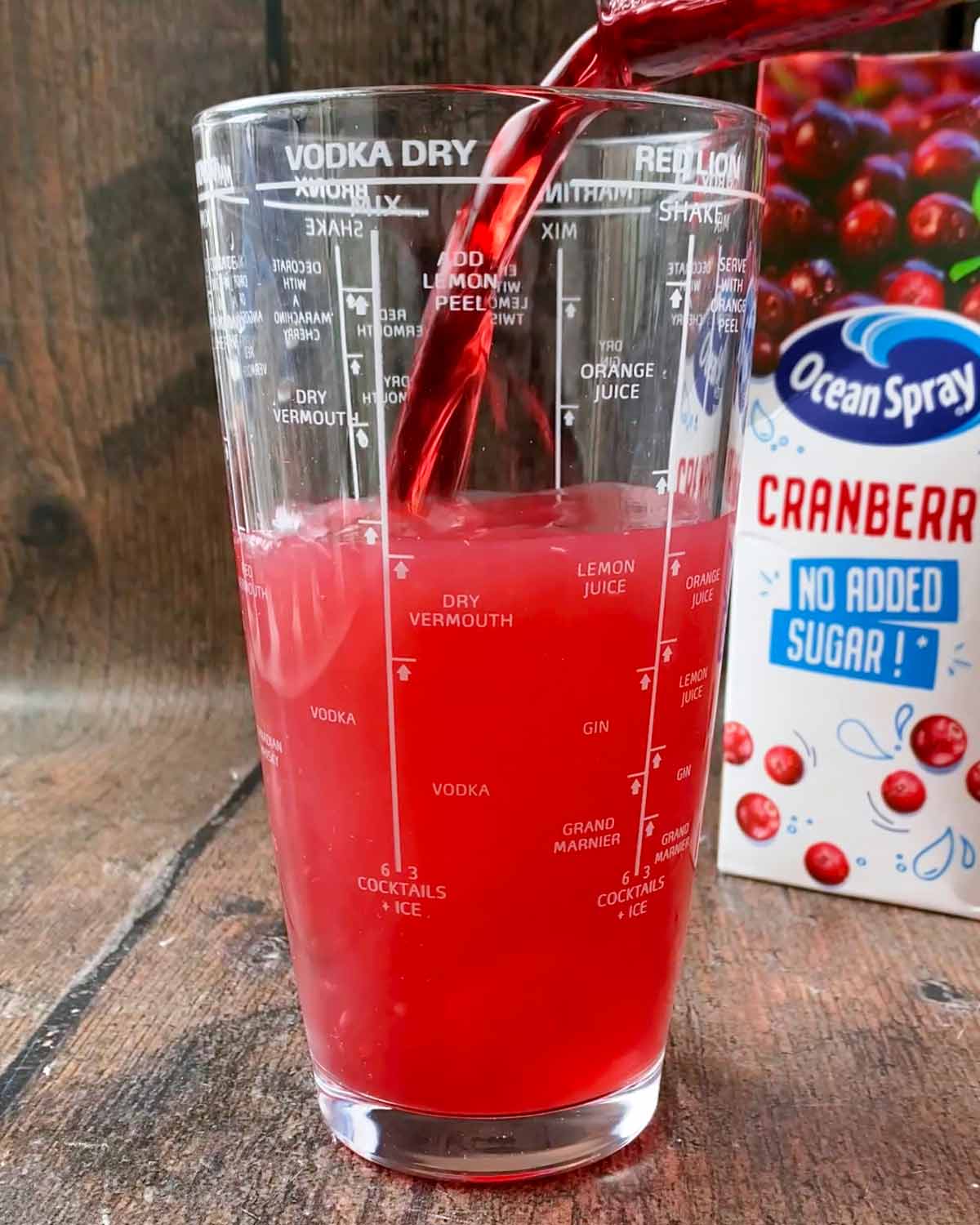 Cranberry juice added to the shaker.