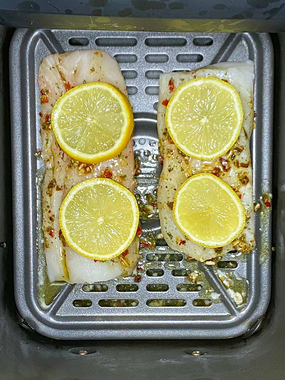 Lemon slices added to the cod.