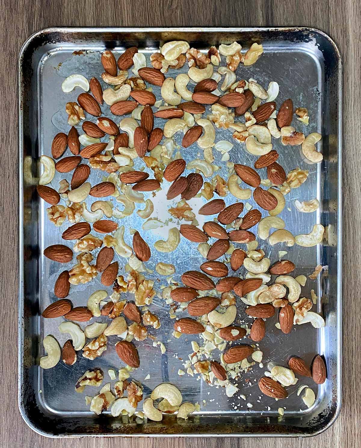 A selection of mixed nuts on a baking sheet.