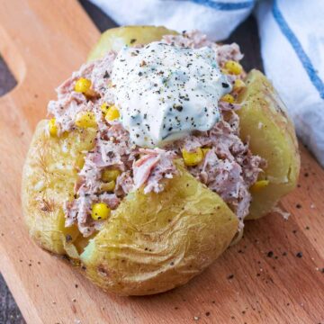 Microwave jacket potato topped with tuna mayonnaise and sour cream.