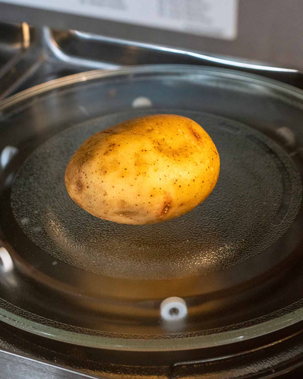 A potato inside a microwave.
