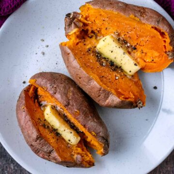 Two microwave sweet potato on a plate.