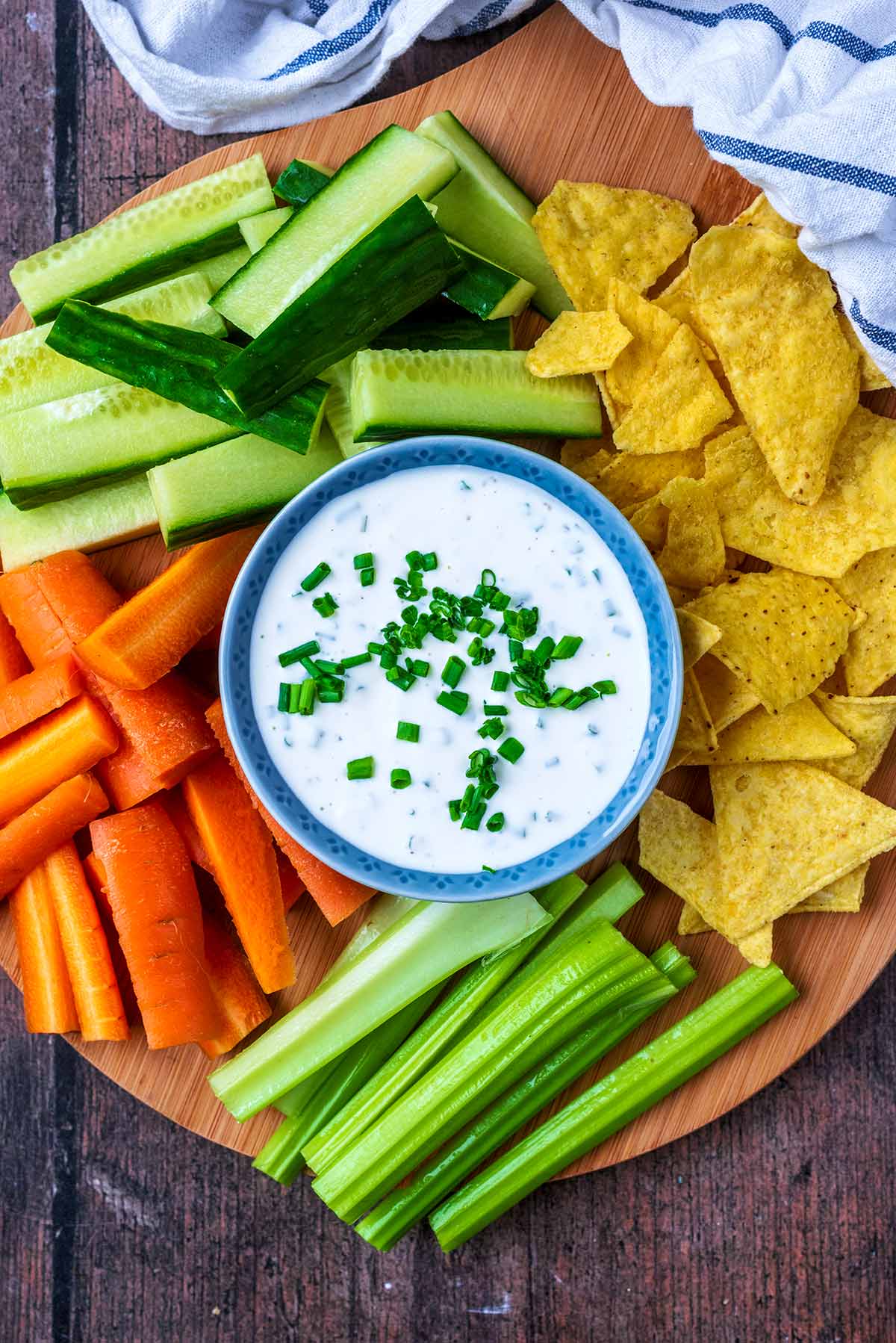 A bowl of creamy dip surrounded by crudités.