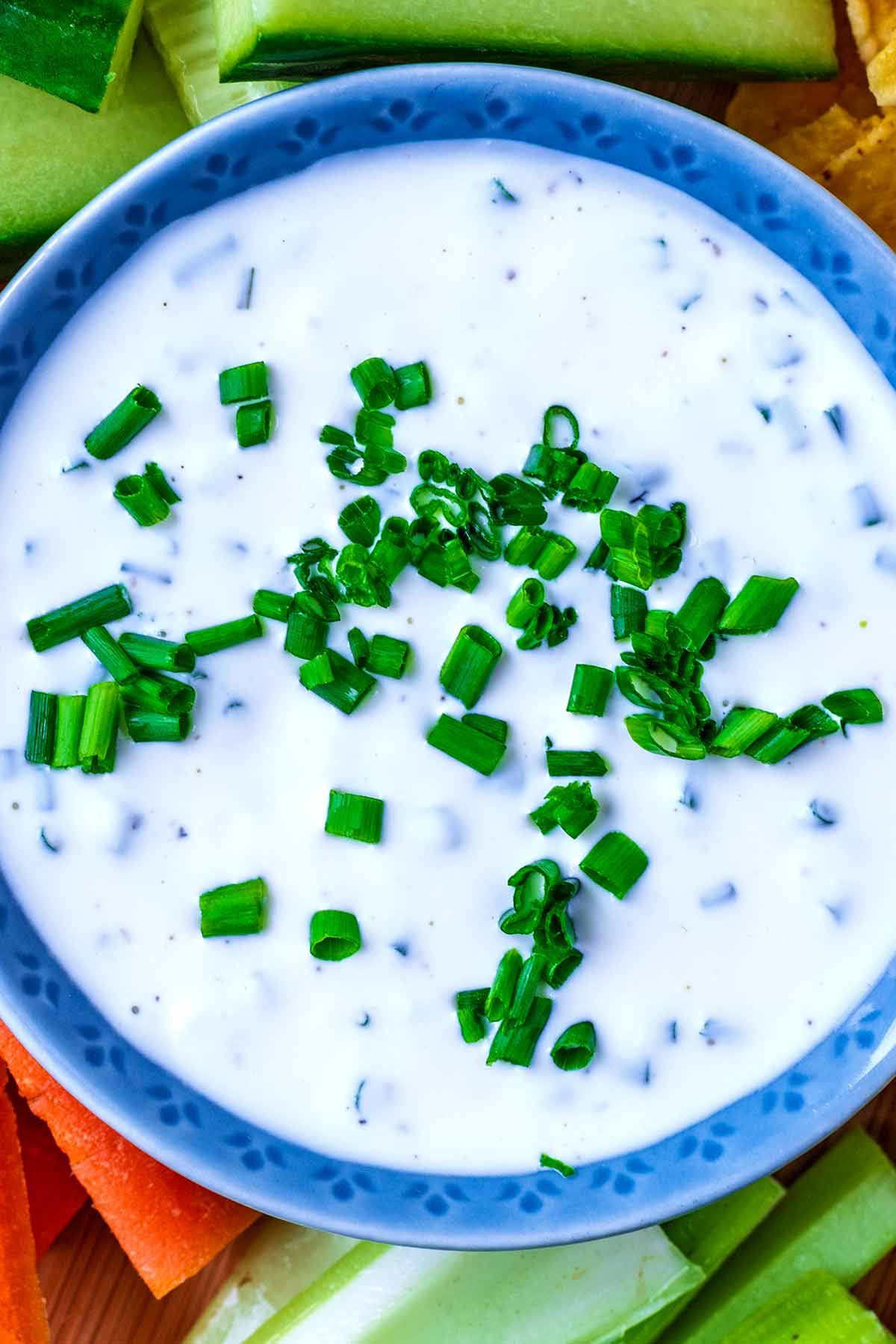 Chopped chives on top of a sour cream dip.