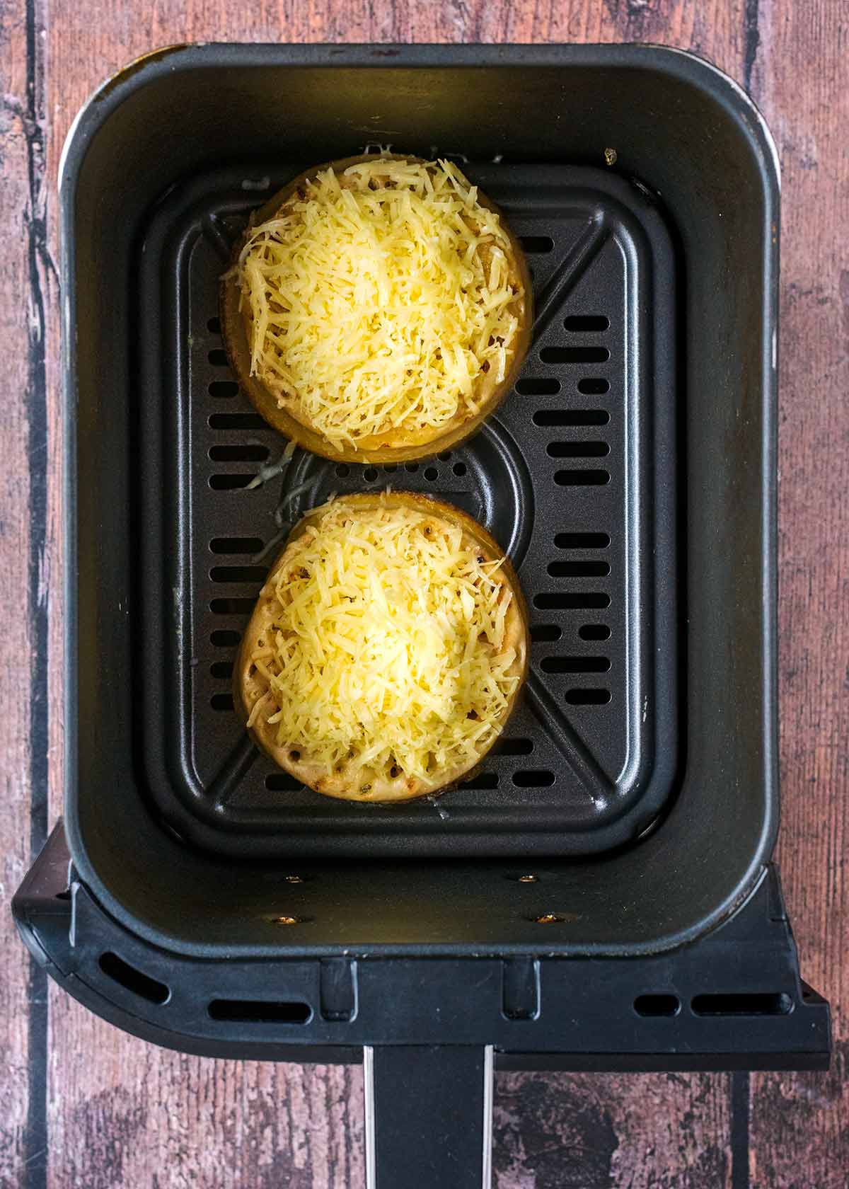 Grated cheese sprinkled over the crumpets.