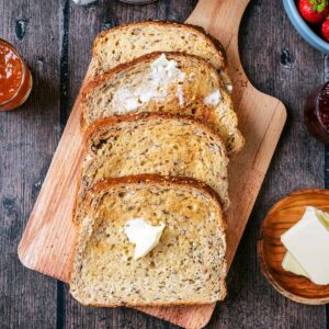 Four slices of air fryer toast on a wooden board.