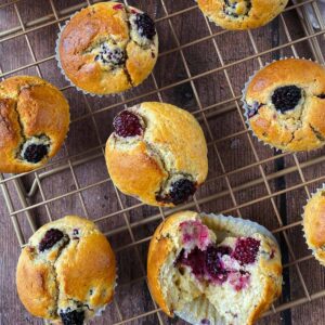 Blackberry muffins on a wire rack.