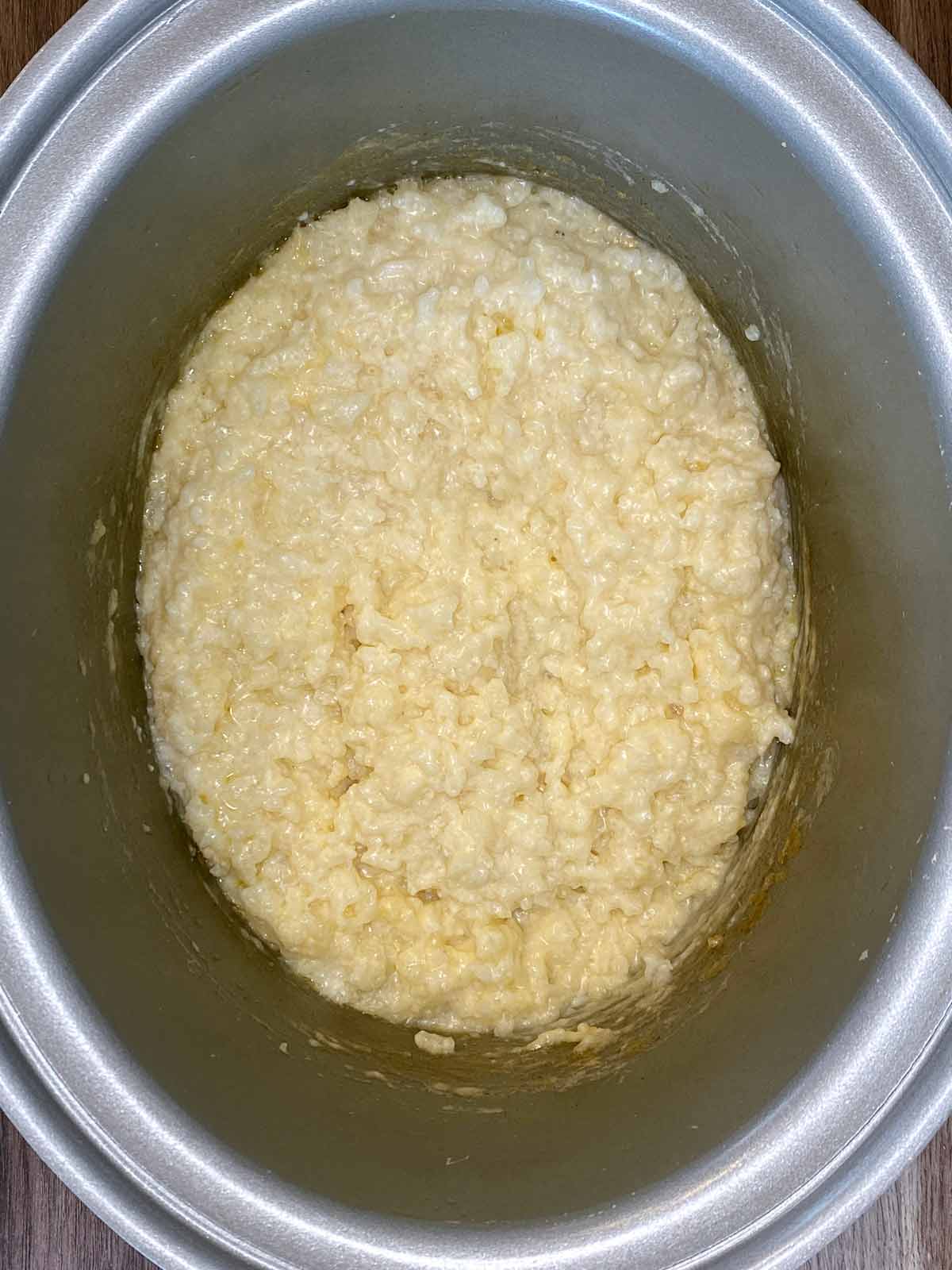 Cooked rice pudding in a slow cooker bowl.