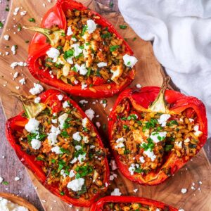 Air fryer stuffed peppers on a wooden board.