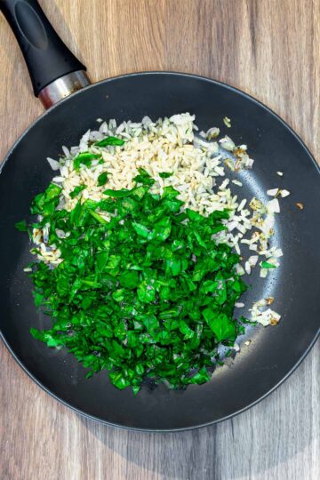 Rice and spinach added to the pan.