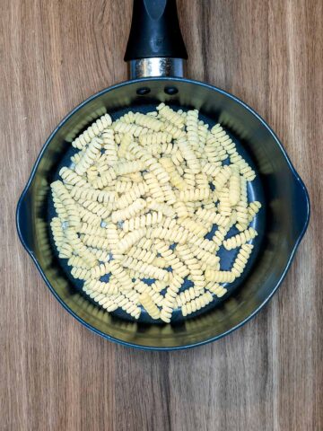 A pan with pasta shapes in it.