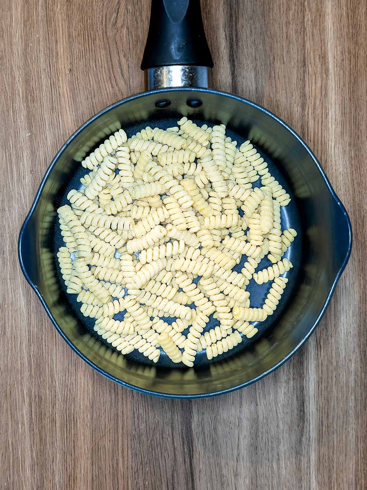 A pan with pasta shapes in it.