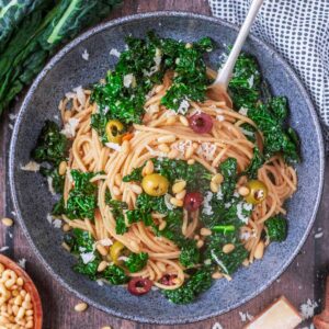 A bowl of cavolo nero pasta with a fork in it.