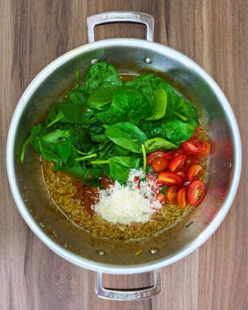 Spinach, tomatoes, parmesan and pesto added to the pan.