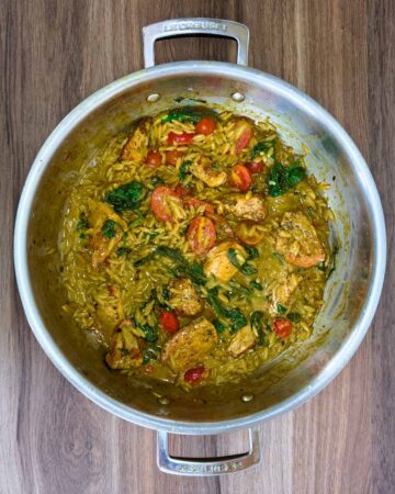 Cooked chicken orzo in a large pan.