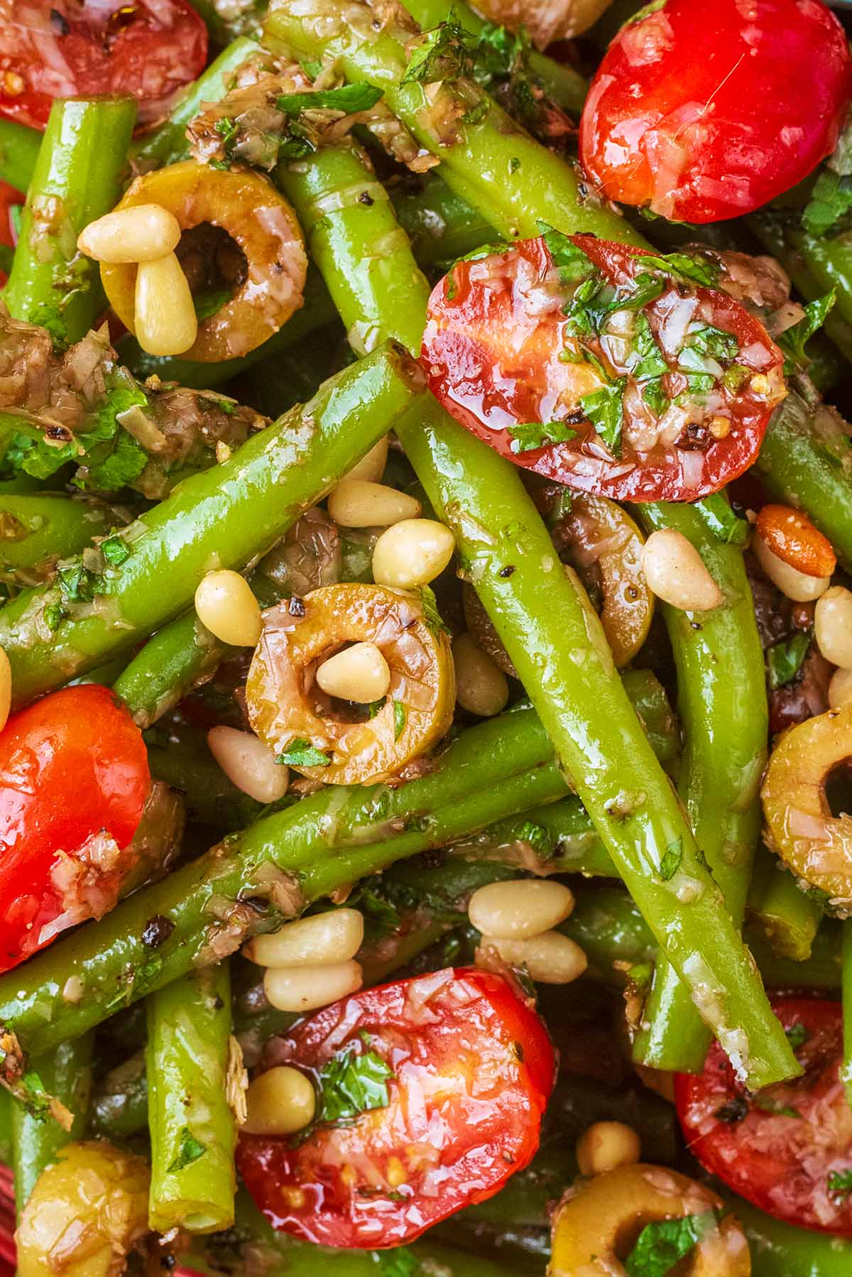 Green beans, olives and cherry tomatoes mixed with a dressing and topped with pine nuts.