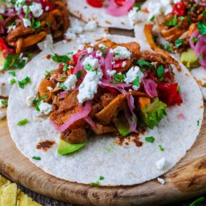 Mushroom tacos on a wooden serving board.