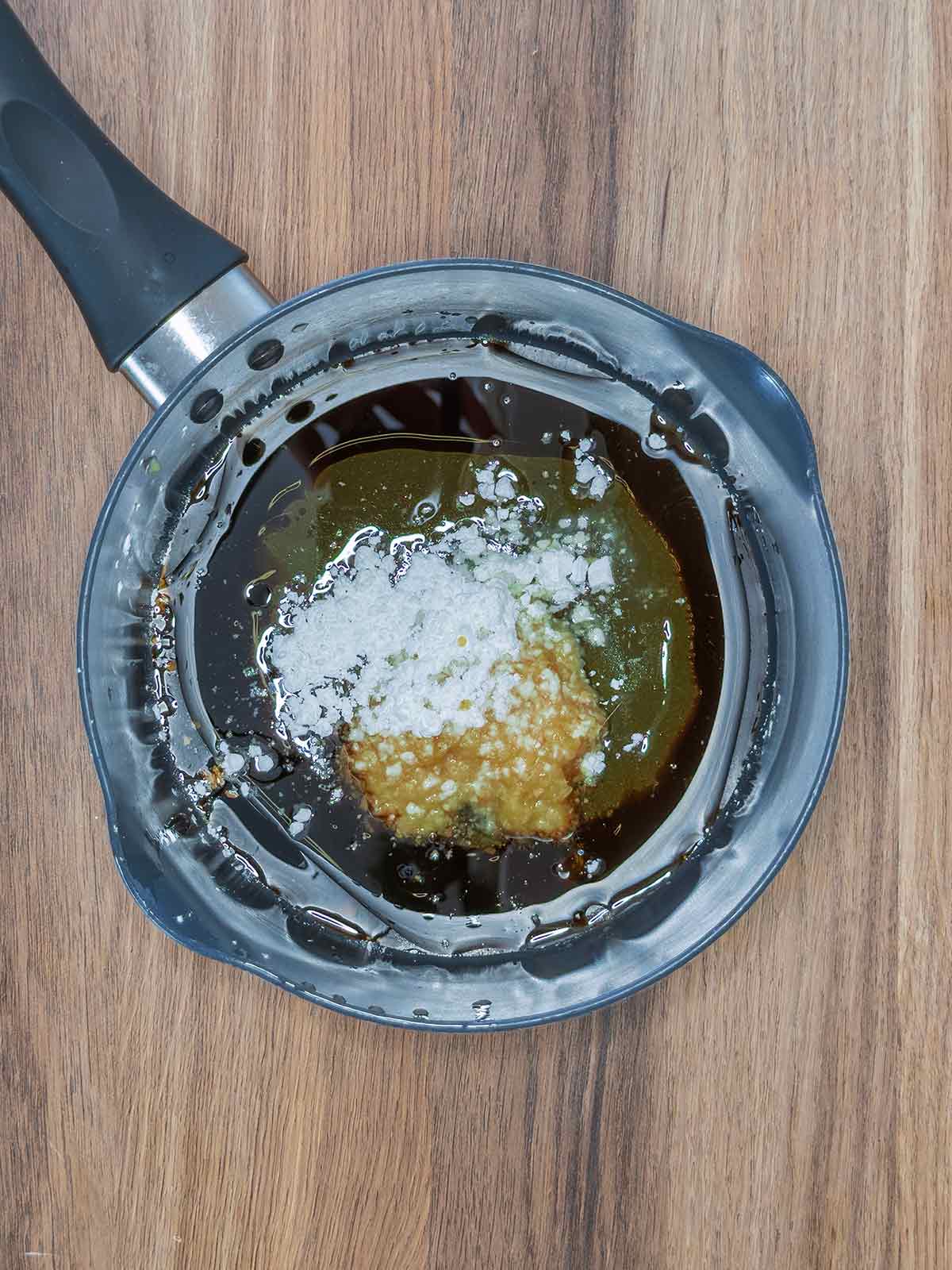 Soy sauce, oil, garlic, ginger and cornflour in a saucepan.