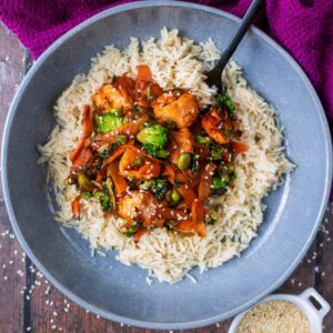 Sticky Salmon Stir Fry on a bed of rice in a bowl.