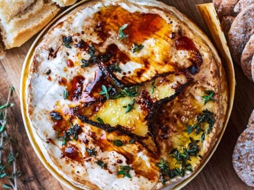 Cooked air fryer camembert on a wooden board.