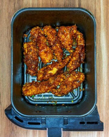 Cooked chicken tenders in an air fryer.