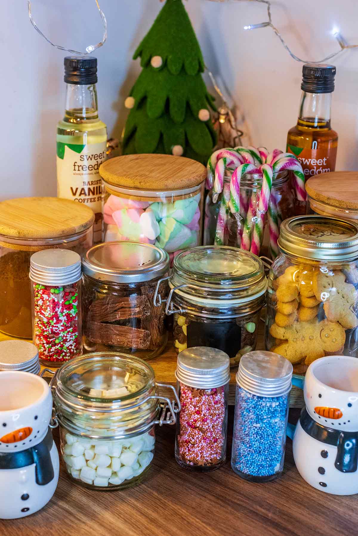 Glass jars filled with various hot chocolate toppings.