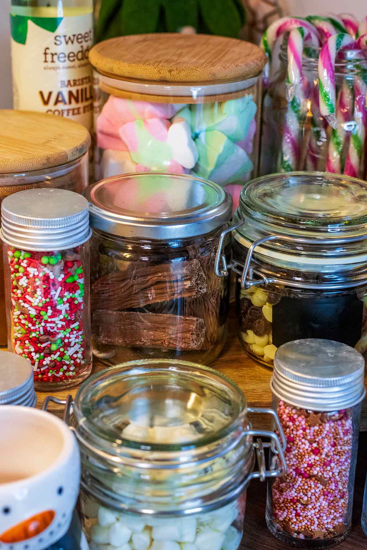 Jar of Christmas shaped marshmallows next to a jar of chocolate flakes.