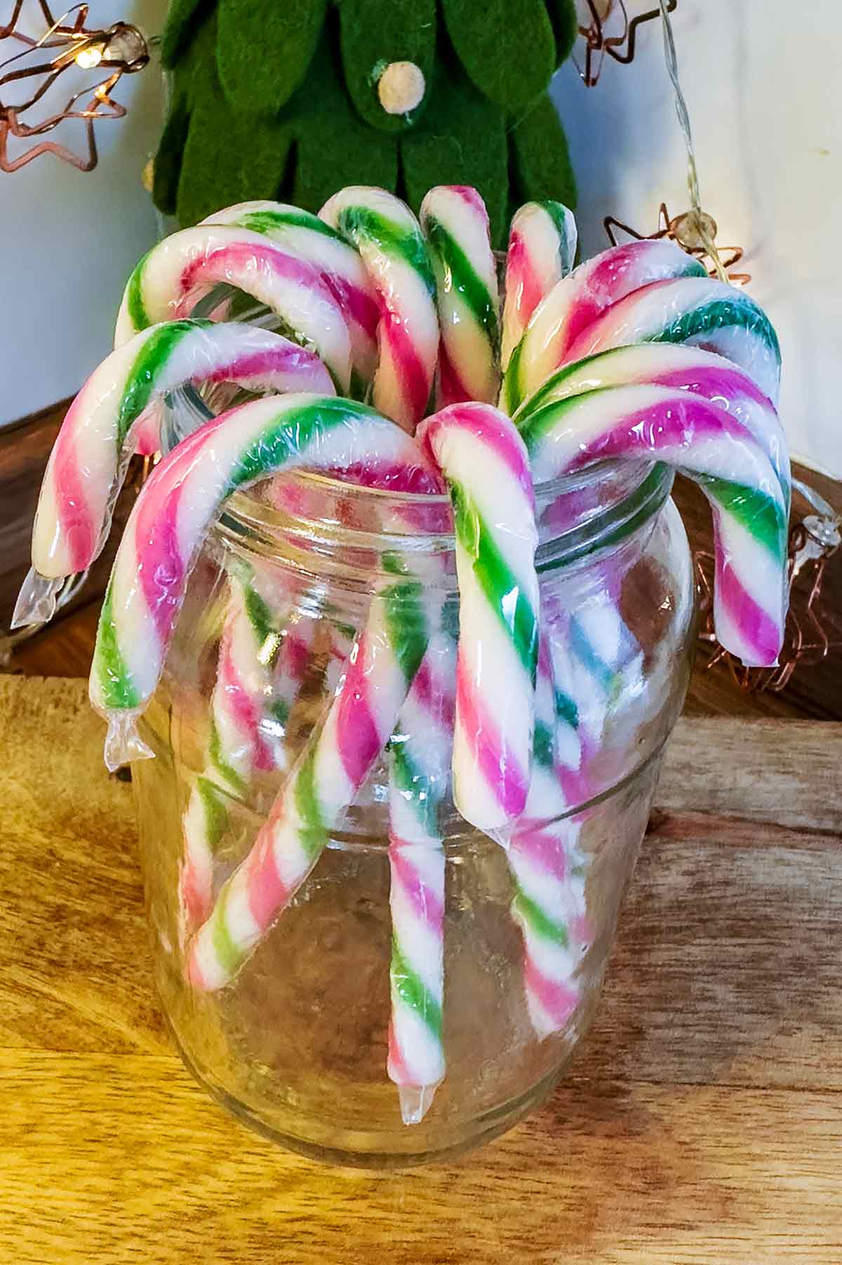 Candy canes arranged in a glass jar.