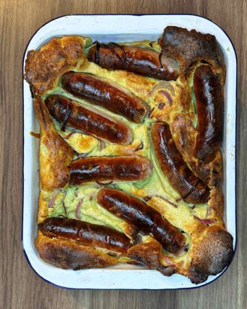 Cooked toad in the hole in a rectangular baking dish.