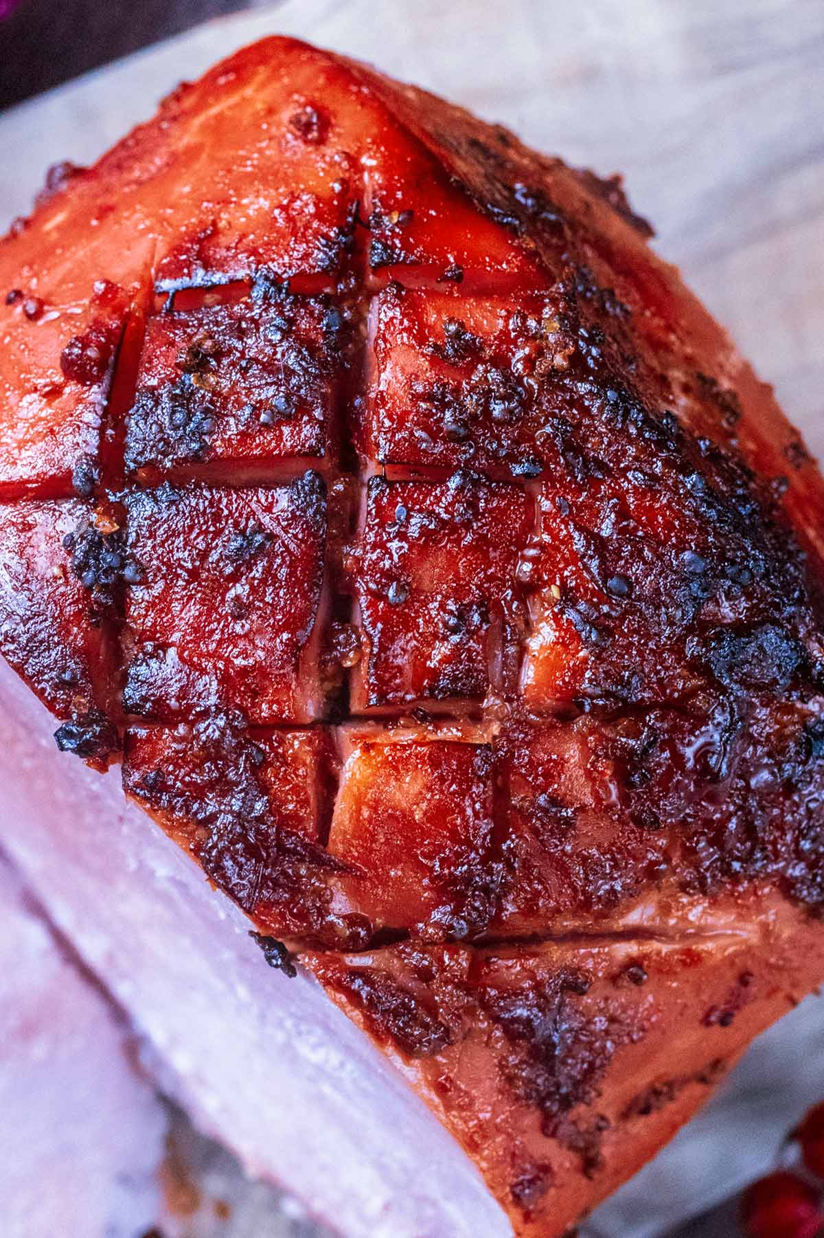 Scored and glazed top of a cooked gammon joint.
