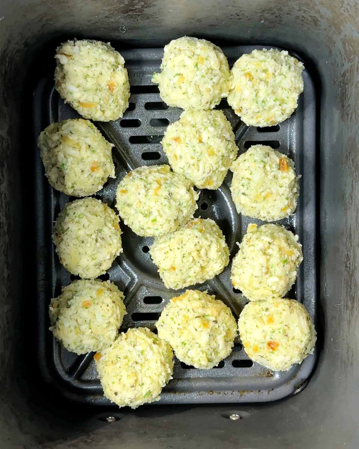 Stuffing balls in an air fryer basket.