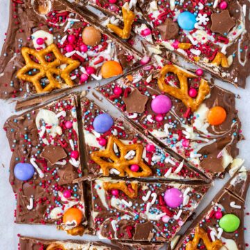 Pieces of Christmas chocolate bark on a sheet of baking paper.